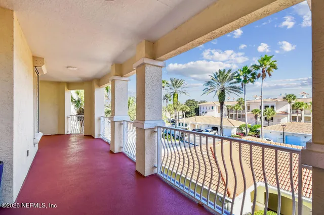 a large bed sitting in a bedroom next to a window