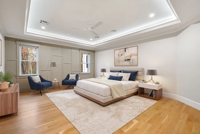 a bedroom with bed couch and window