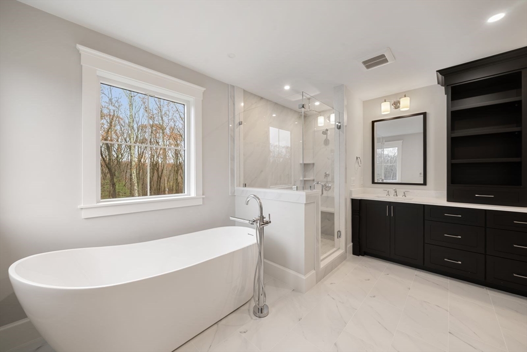 3 Whisper Way Hopkinton, MA 01748 - Photo 18 of 24 a spacious bathroom with a bathtub double sink and mirror