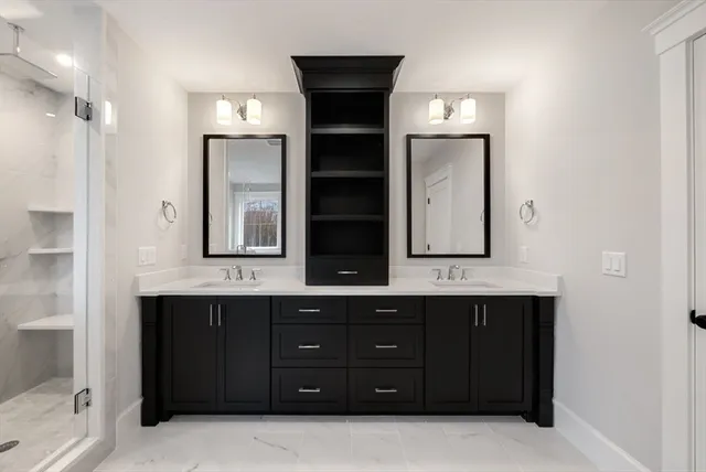 a bathroom with a double vanity sink and mirror