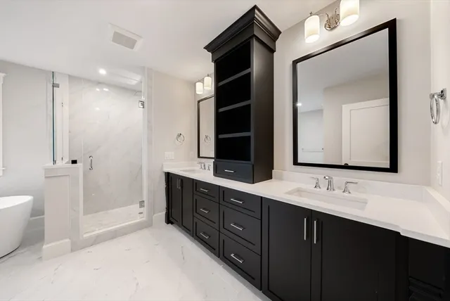 a bathroom with a double vanity sink and a mirror