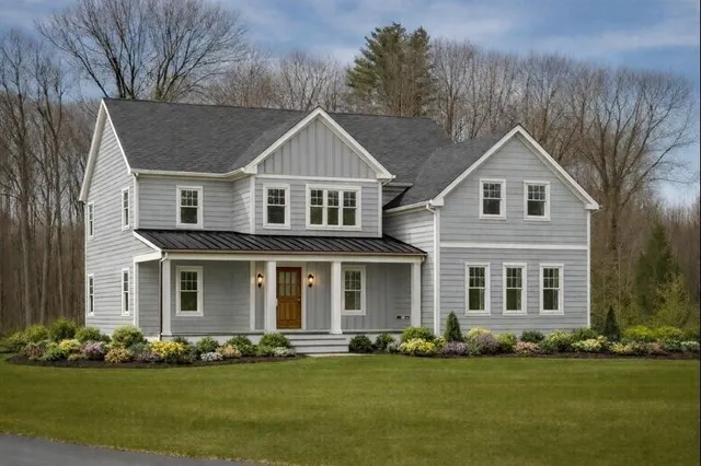 front view of a brick house with a yard