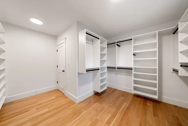 a view of walk in closet with empty racks