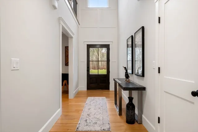 a view of a hallway with a window and wooden floor