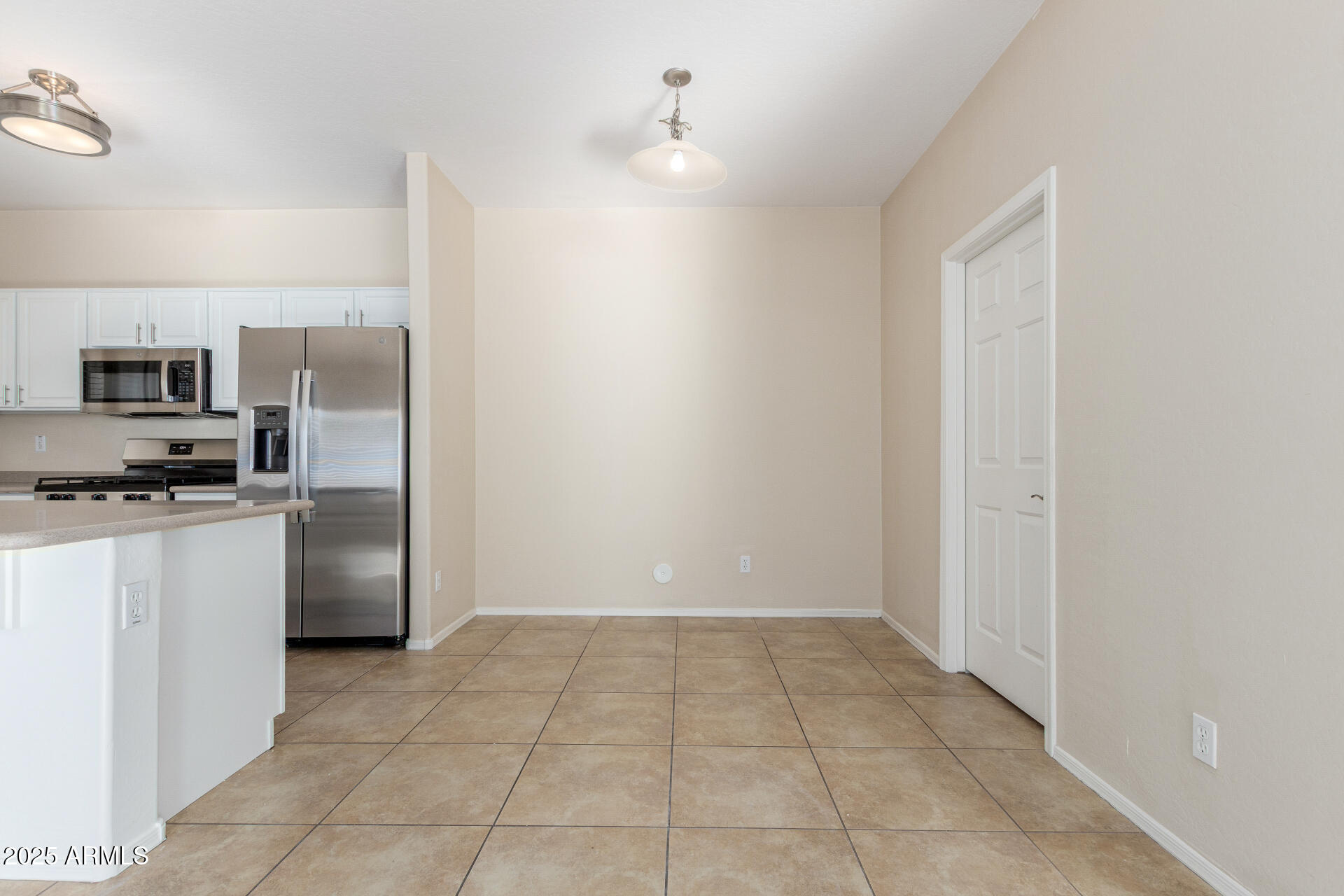 4480 South Marble Street Gilbert, AZ 85297 - Photo 11 of 26 a view of a kitchen with a sink a refrigerator and a stove
