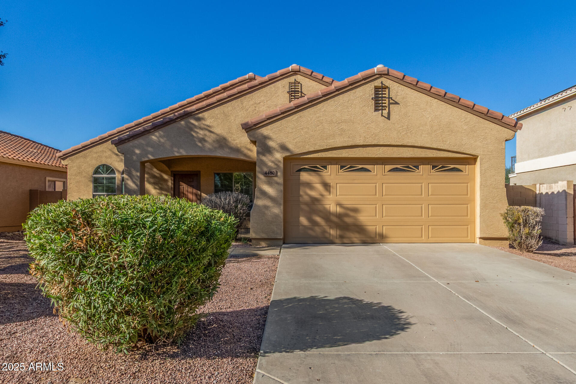 4480 South Marble Street Gilbert, AZ 85297 - Photo 2 of 26 a front view of a house with a yard and garage