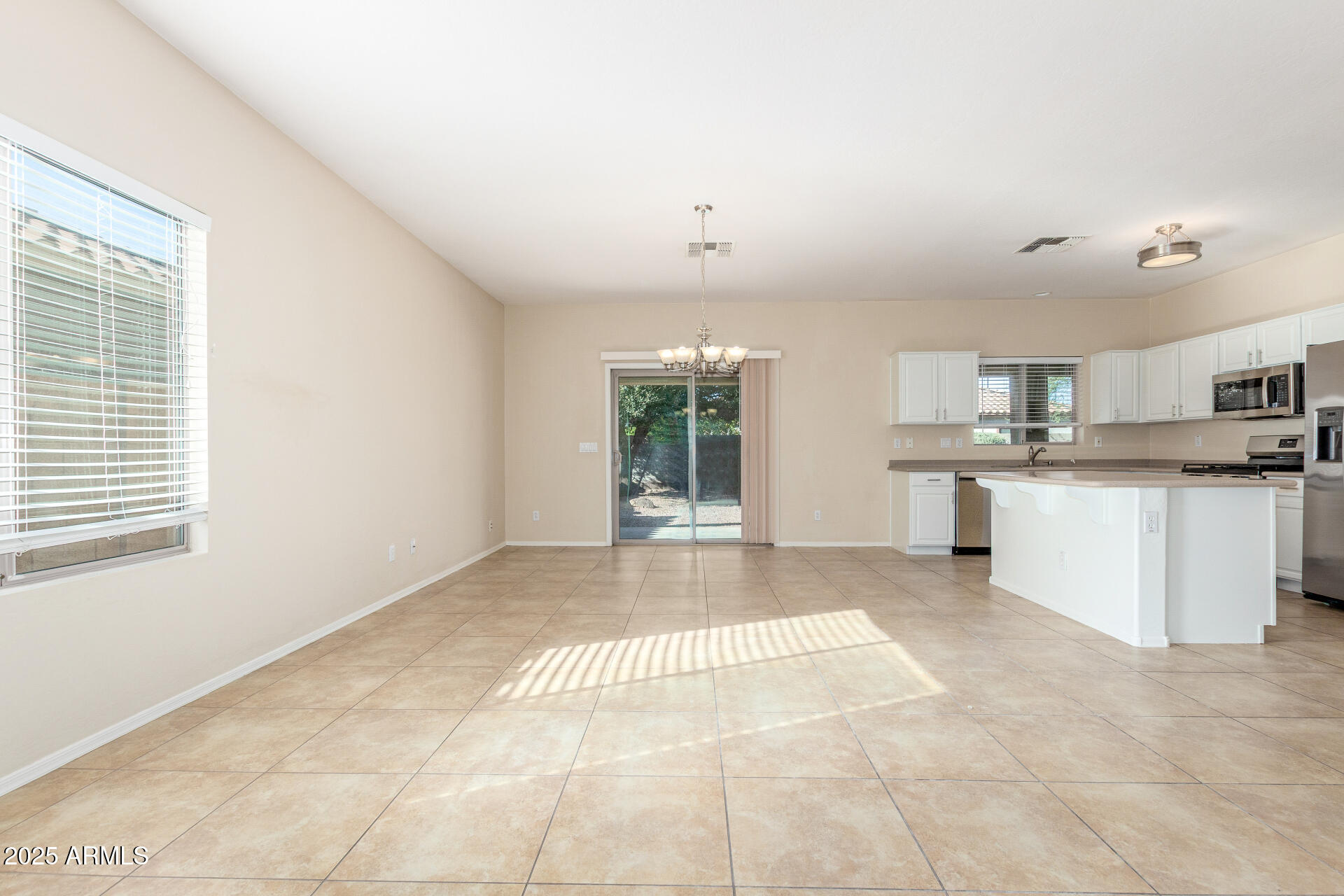 4480 South Marble Street Gilbert, AZ 85297 - Photo 6 of 26 a view of kitchen with stainless steel appliances granite countertop a stove top oven a sink a window and white cabinets