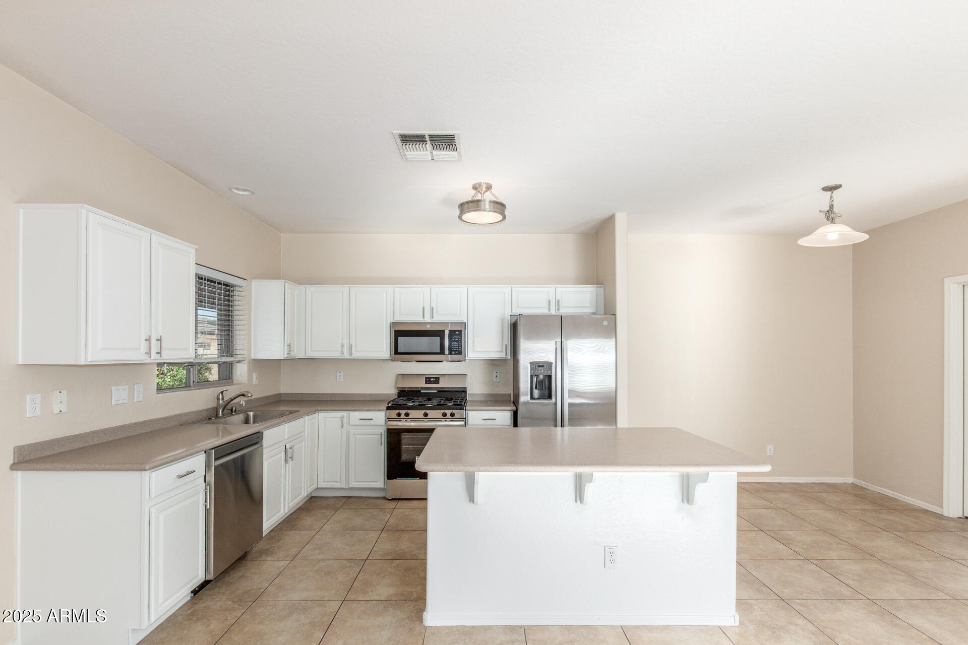 4480 South Marble Street Gilbert, AZ 85297 - Photo 8 of 26 a large kitchen with cabinets and stainless steel appliances