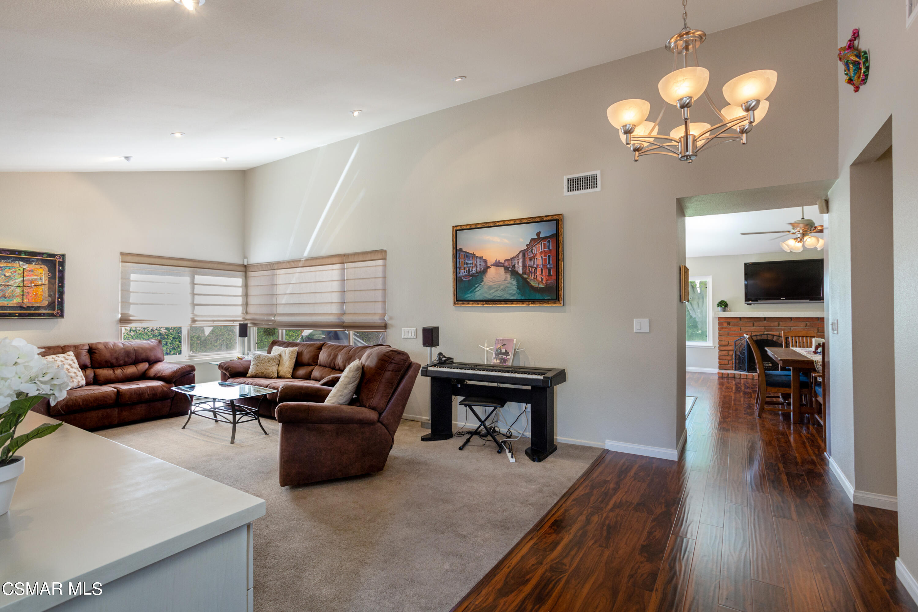 2641 Greenleaf Court Simi Valley, CA 93063 - Photo 3 of 25 a living room with furniture a chandelier a large window and wooden floor