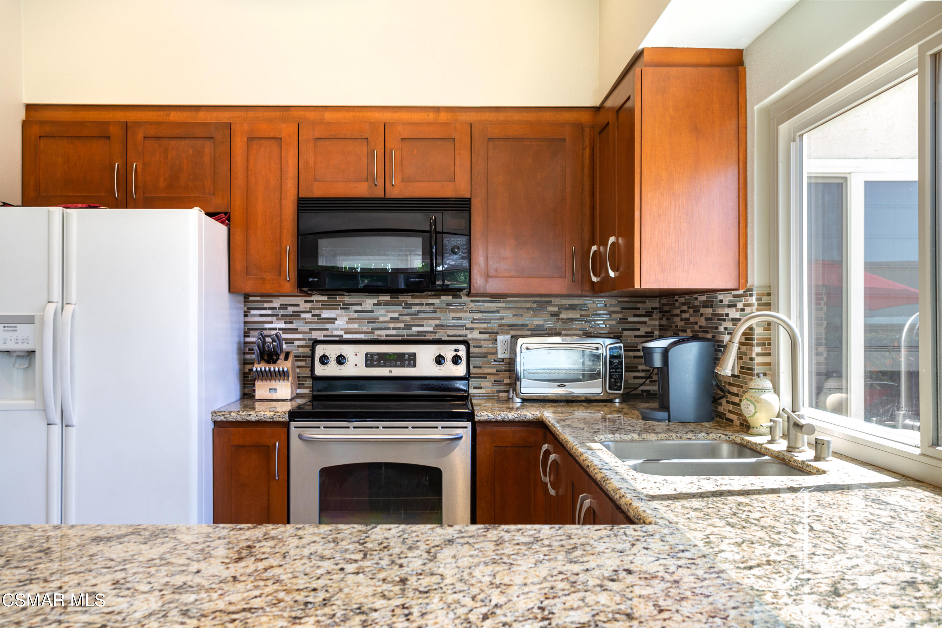 2641 Greenleaf Court Simi Valley, CA 93063 - Photo 9 of 25 a kitchen with a refrigerator stove and sink