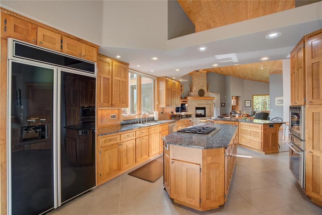 52 Rounds Road Breckenridge, CO 80424 - Photo 11 of 35 a kitchen with stainless steel appliances granite countertop a refrigerator a sink dishwasher a stove and white cabinets with wooden floor
