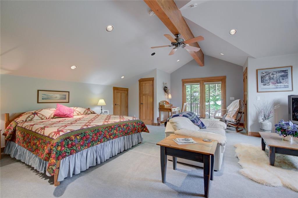 52 Rounds Road Breckenridge, CO 80424 - Photo 26 of 35 a bedroom with a bed a chandelier and dresser