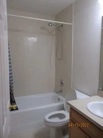 a bathroom with a toilet and a bath tub