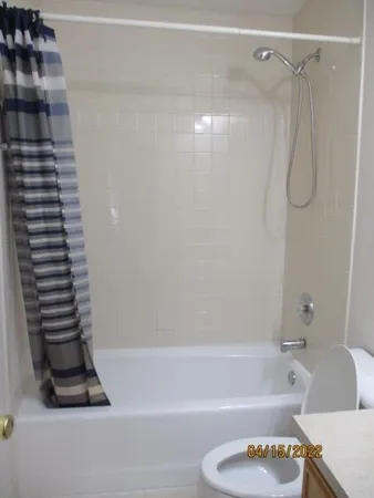 a bathroom with a shower a toilet and a shower