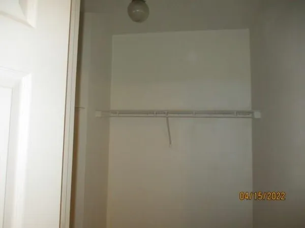 en empty room with a ceiling fan