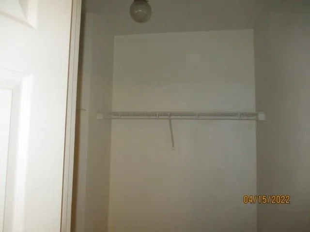 en empty room with a ceiling fan