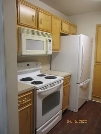 a stove top oven sitting inside of a kitchen