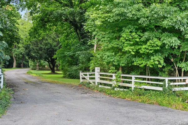 a view of a yard with wooden fence