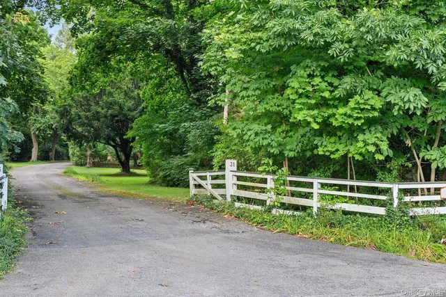 a view of a yard with wooden fence