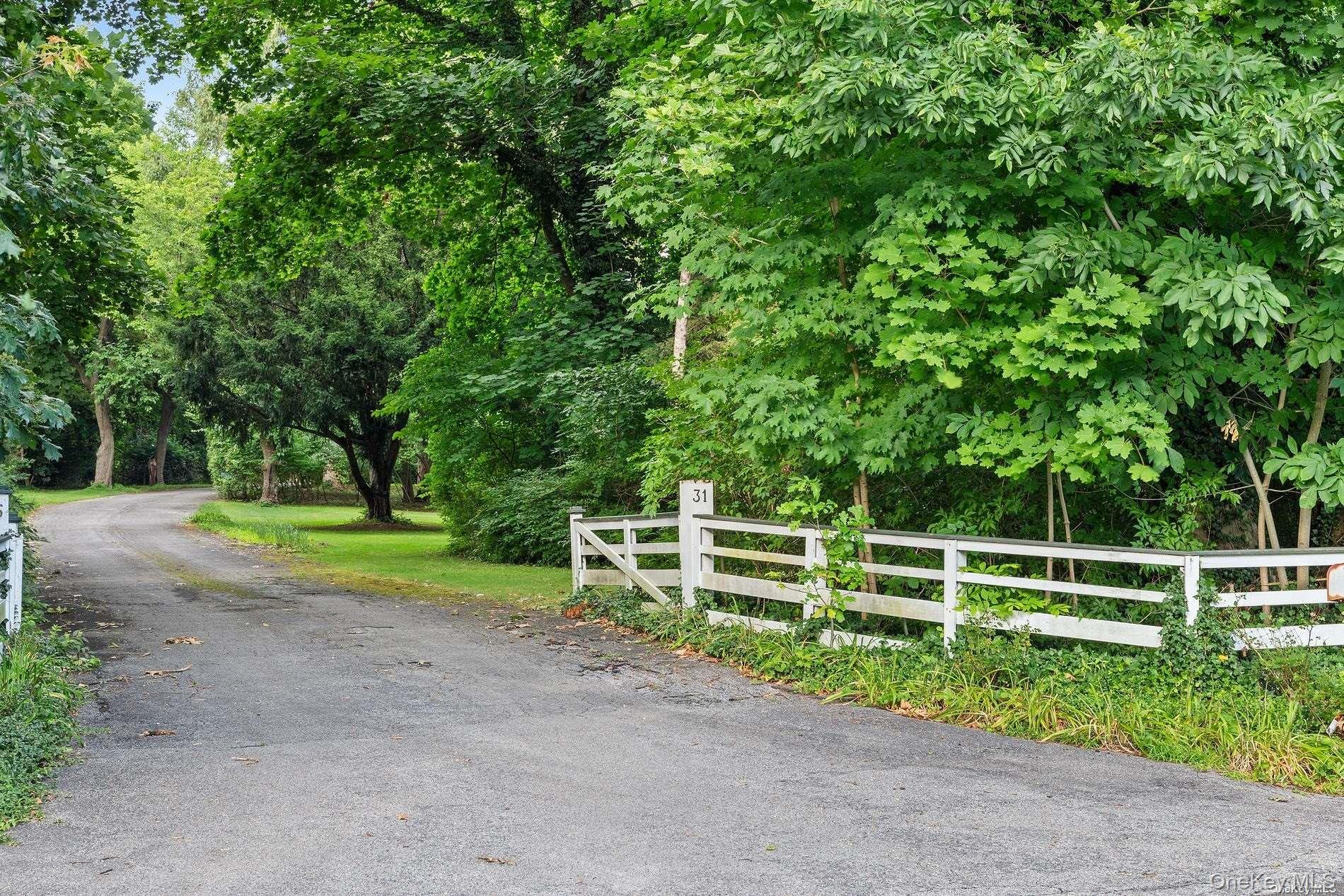 31 Factory Pond Road Locust Valley, NY 11560 - Photo 9 of 14 a view of a yard with wooden fence