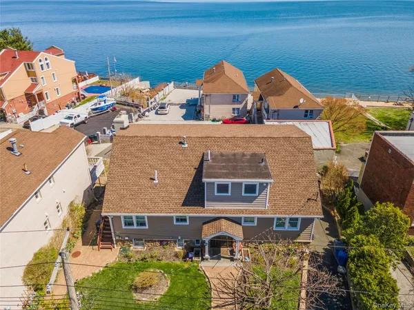 an aerial view of a house with a yard