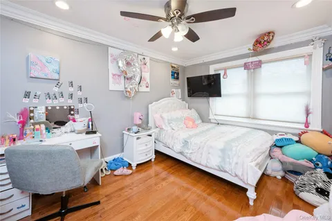 a bedroom with furniture and a flat screen tv