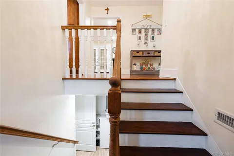 a view of staircase with white walls and a window