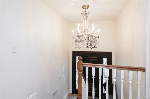 a view of a hallway with a chandelier