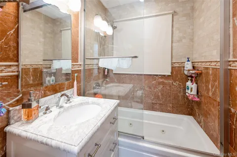 a bathroom with a tub and a sink