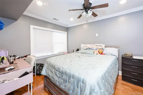 a bedroom with a bed and a desk