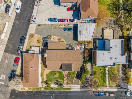 an aerial view of residential houses with outdoor space