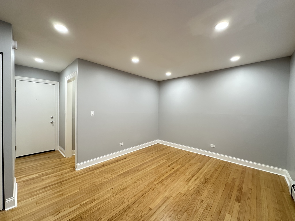6954 North Sheridan Road, Unit 312 Chicago, IL 60626 - Photo 15 of 21 an empty room with wooden floor and windows