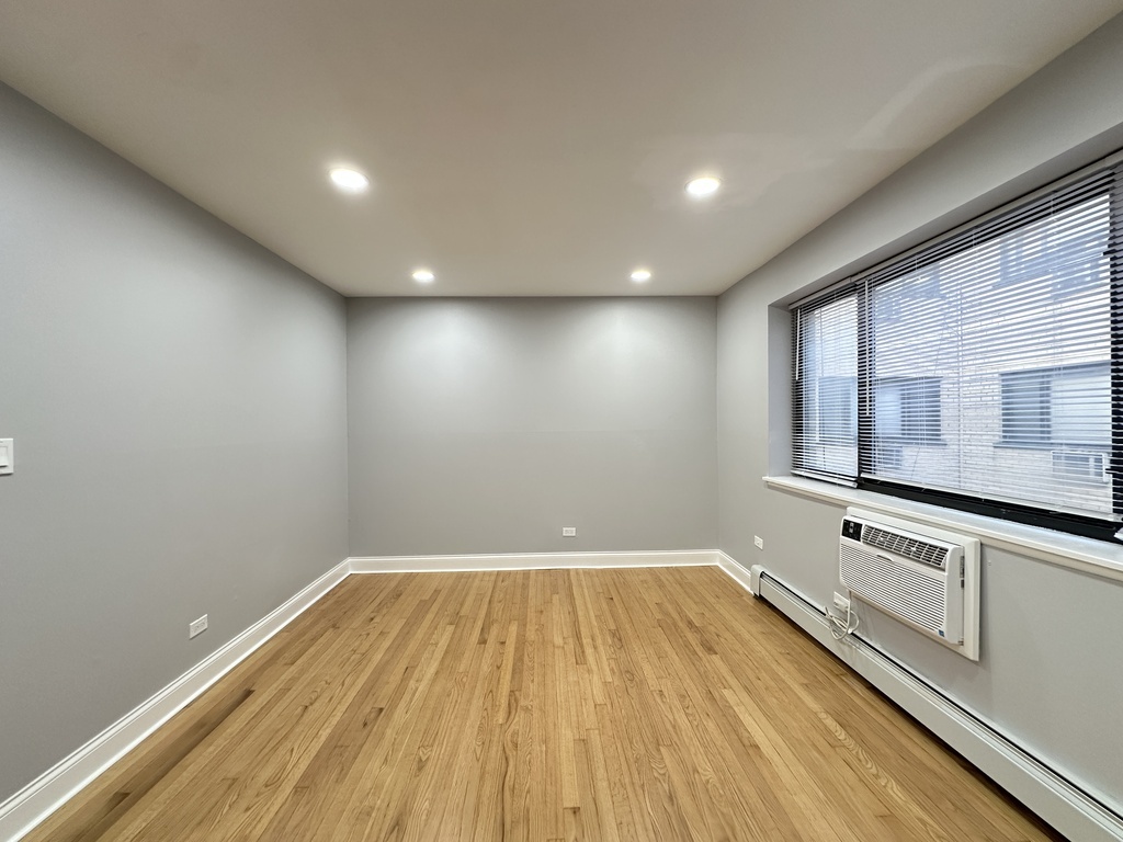 6954 North Sheridan Road, Unit 312 Chicago, IL 60626 - Photo 16 of 21 a view of a room with wooden floors and mirrors