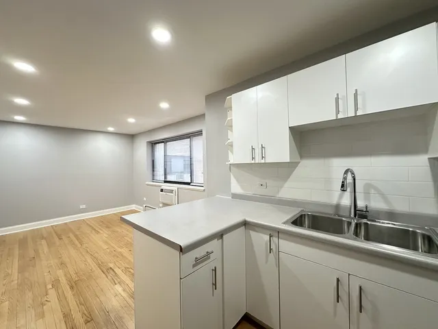 a kitchen with a sink and cabinets