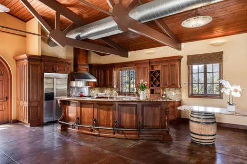 a kitchen with sink and wooden cabinets