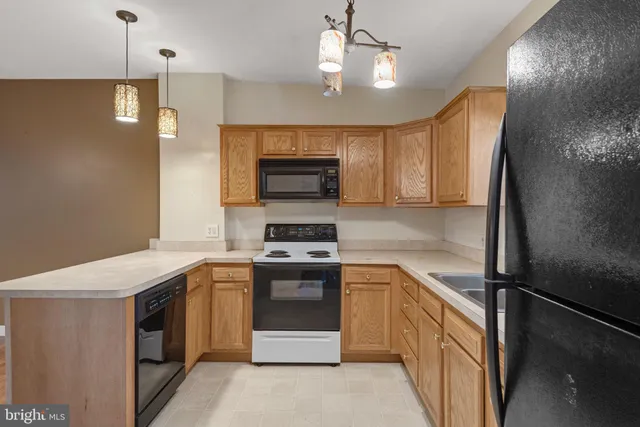 a kitchen with a sink stove and microwave