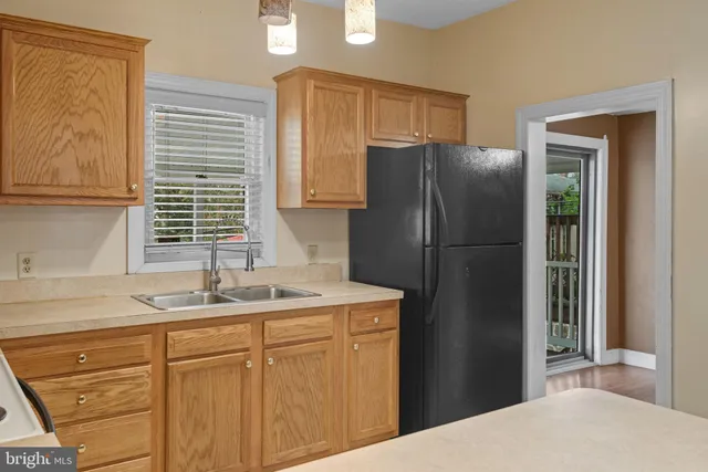 a kitchen with a refrigerator and a sink