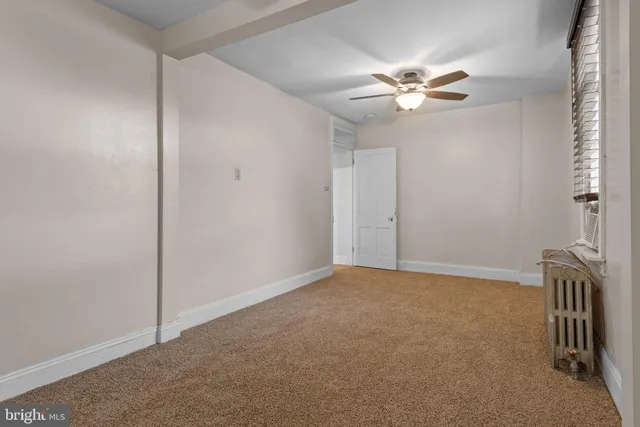 a view of an empty room with a fan