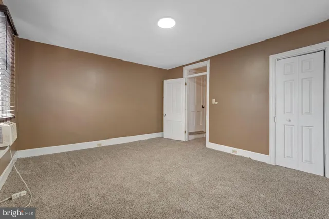 an empty room with closet area