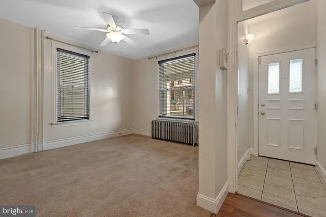an empty room with windows and closet