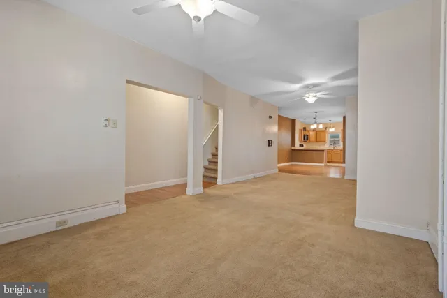 an empty room with a empty space and chandelier fan