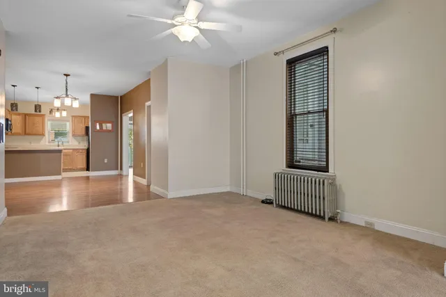a view of livingroom with hardwood floor and kitchen view