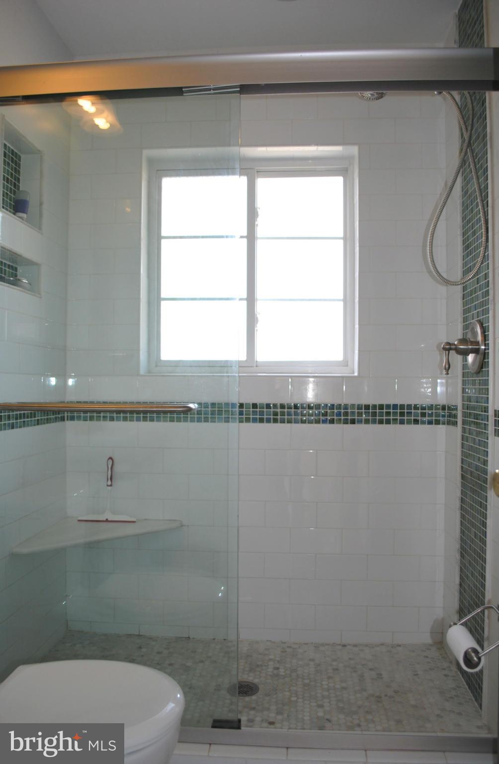 10134 Dallas Avenue Silver Spring, MD 20901 - Photo 16 of 27 a bathroom with a granite countertop sink a toilet and a mirror