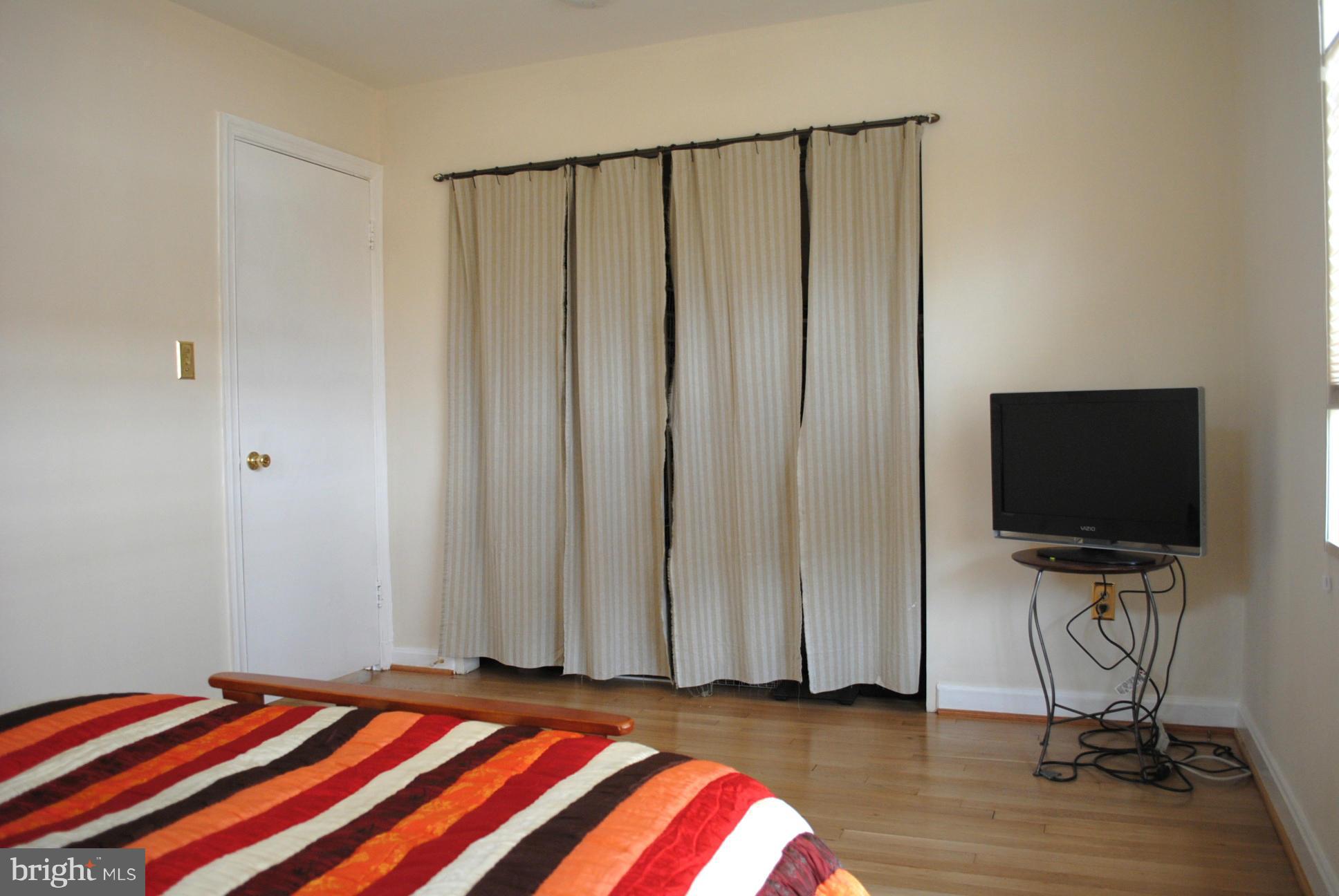 10134 Dallas Avenue Silver Spring, MD 20901 - Photo 18 of 27 a bedroom with a bed and a flat screen tv