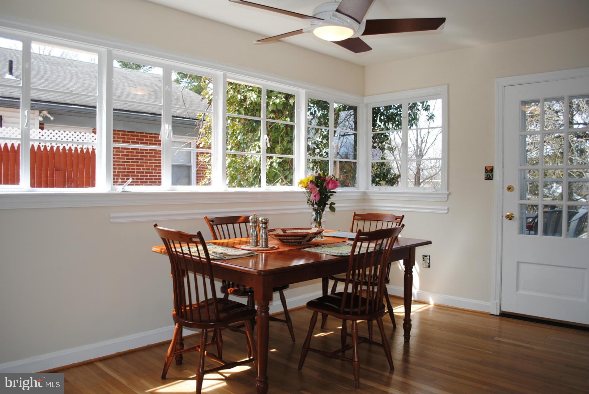 10134 Dallas Avenue Silver Spring, MD 20901 - Photo 8 of 27 a view of a dining room with furniture wooden floor and a chandelier