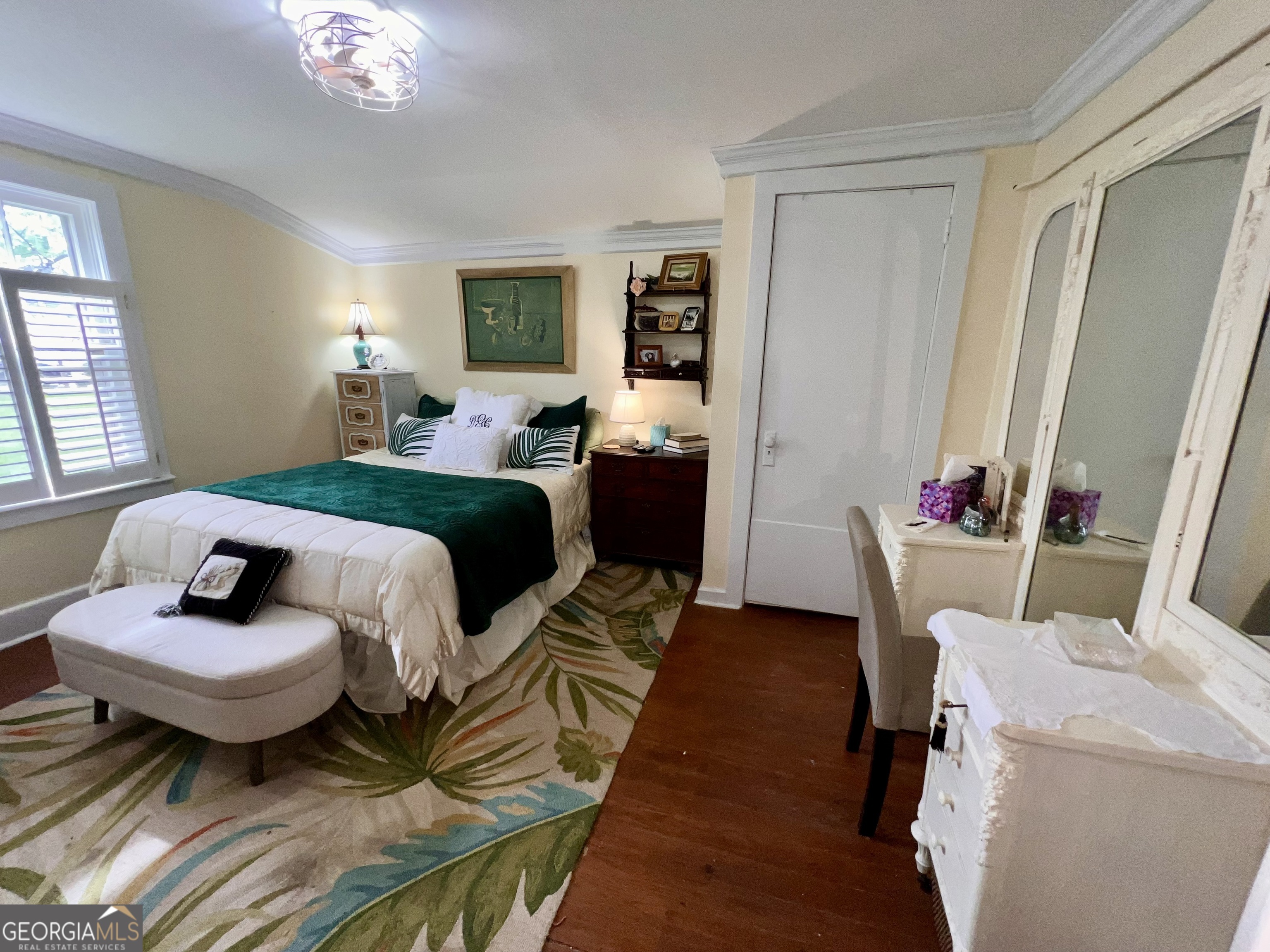 600 Foster Street Madison, GA 30650 - Photo 21 of 54 a bedroom with a bed and flat screen tv