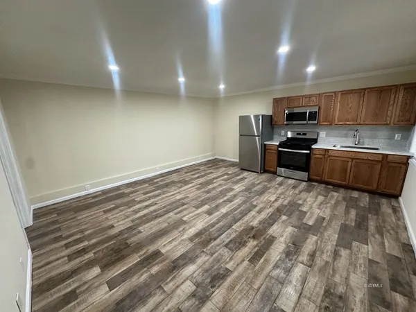 a large kitchen with kitchen island a sink stainless steel appliances and cabinets