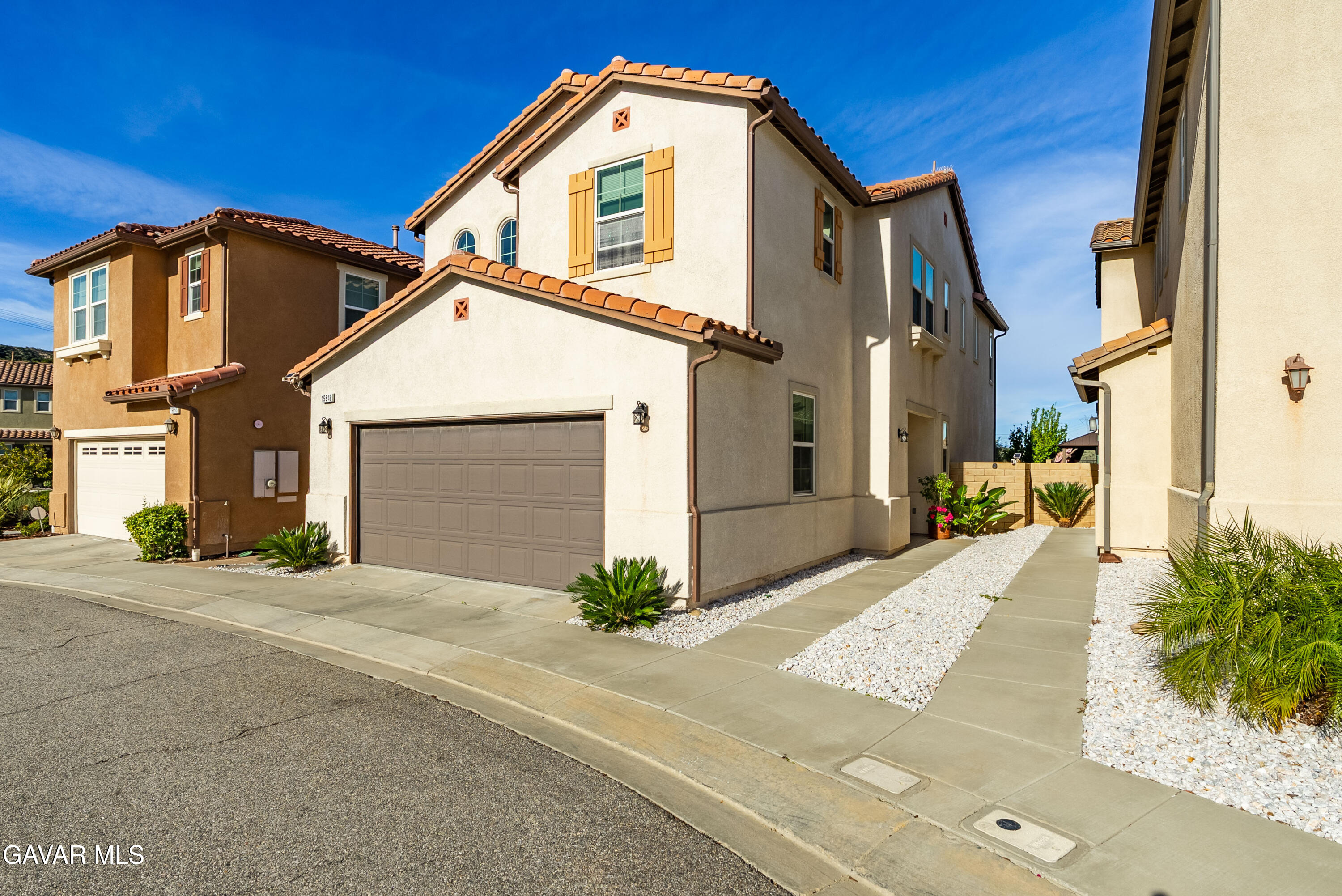 19849 Via Ott Santa Clarita, CA 91321 - Photo 11 of 52 a front view of a house with a yard and garage