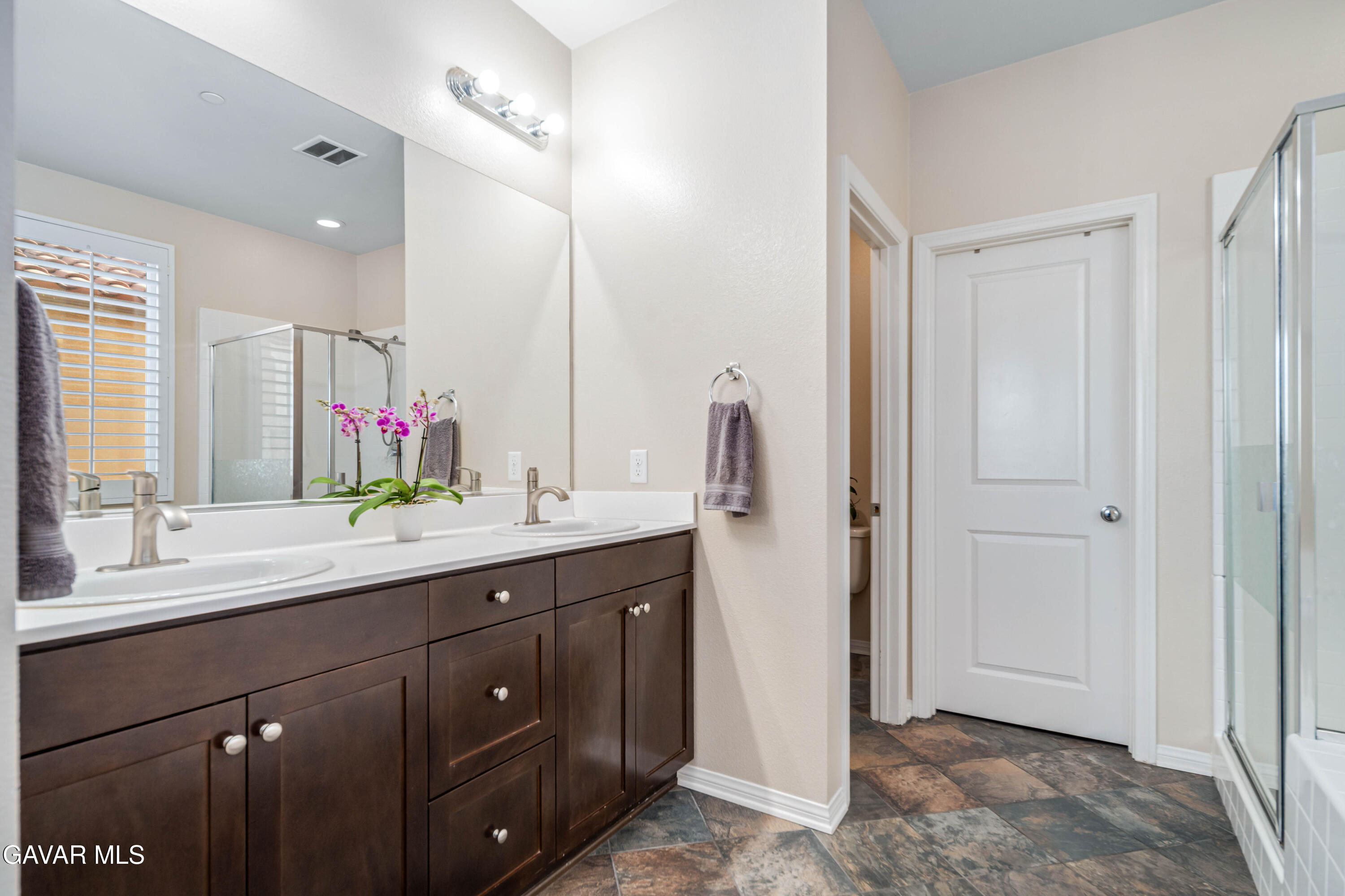 19849 Via Ott Santa Clarita, CA 91321 - Photo 35 of 52 a bathroom with a double vanity sink and mirror