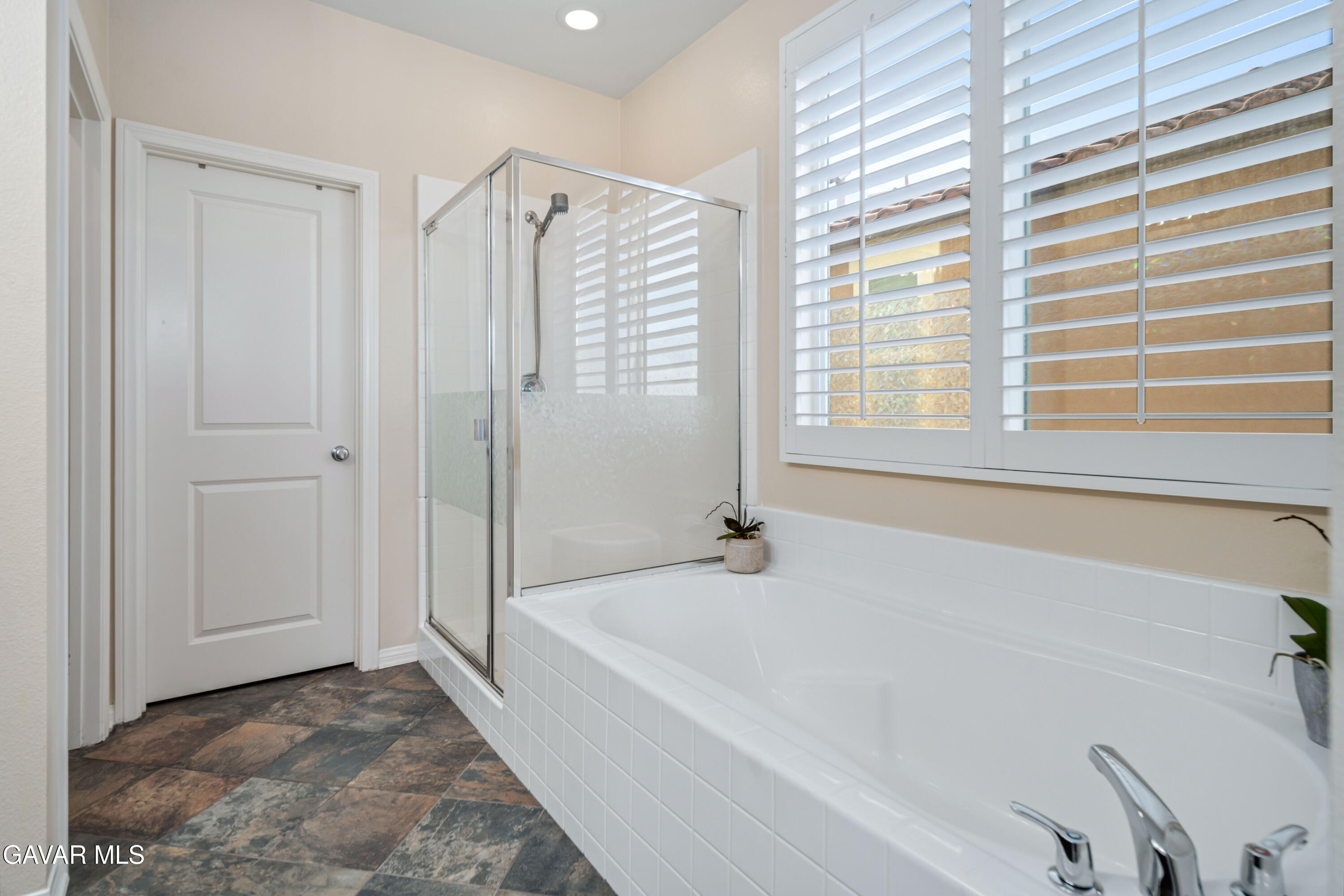 19849 Via Ott Santa Clarita, CA 91321 - Photo 42 of 52 a spacious bathroom with bathtub and shower